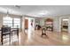 Inviting living room featuring hardwood floors, a dining area with a modern chandelier, and natural light at 1276 Bermuda St, Clearwater, FL 33755