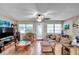 Cozy living room featuring hardwood floors, a ceiling fan, and ample natural light at 1276 Bermuda St, Clearwater, FL 33755