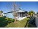 A view of the screened in back porch with a view of the lawn and landscaping at 13102 Barth Pl, Riverview, FL 33579