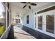 A view of the screened in back porch with tiled floor and ceiling fans at 13102 Barth Pl, Riverview, FL 33579