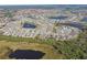 Aerial view of large community with lake and houses at 13355 Waterleaf Garden Cir, Riverview, FL 33579