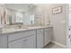 Double vanity bathroom with granite countertops and gray cabinets at 13355 Waterleaf Garden Cir, Riverview, FL 33579