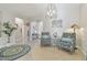 Elegant entryway with two armchairs, a circular rug, and decorative lighting at 13355 Waterleaf Garden Cir, Riverview, FL 33579