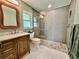 Updated bathroom with walk-in shower and marble vanity at 1336 Stonehaven Ln, Dunedin, FL 34698