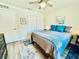 Bedroom with ceiling fan, wood-look floors, and ensuite bath at 1336 Stonehaven Ln, Dunedin, FL 34698