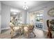 Elegant dining area with a glass table and wicker chairs at 141 Glendower Cir # 250, Sun City Center, FL 33573