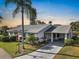 Single story home with palm trees and landscaped yard at 141 Glendower Cir # 250, Sun City Center, FL 33573