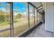 A screened porch that provides an outdoor relaxation space with lovely views of nature at 16216 Rambling Vine W Dr, Tampa, FL 33624