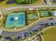 Aerial view of community tennis and basketball courts with parking at 18863 Roseate Dr, Lutz, FL 33558