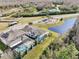 An aerial view of home with pool in a well-maintained neighborhood at 18863 Roseate Dr, Lutz, FL 33558