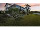 A view of the backyard with a screened pool at sunset at 18863 Roseate Dr, Lutz, FL 33558