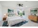 Bright bedroom featuring neutral colors, plush bedding, and natural light from two windows at 18863 Roseate Dr, Lutz, FL 33558