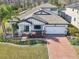 Beautiful single-story home with brick driveway, well-manicured lawn, and appealing architectural details at 18863 Roseate Dr, Lutz, FL 33558