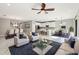 Spacious open-concept living area with modern furnishings, dining area, and a white kitchen at 18863 Roseate Dr, Lutz, FL 33558