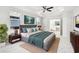 Spacious main bedroom featuring tray ceiling, neutral walls, and ensuite bathroom entrance at 18863 Roseate Dr, Lutz, FL 33558