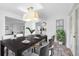 Modern dining room with dark wood table and view to living room at 2050 Glenridge Dr, Spring Hill, FL 34609