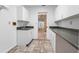 Laundry room with sink and built-in cabinets at 2050 Glenridge Dr, Spring Hill, FL 34609