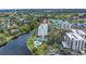 An aerial view shows the property's pool, lake and surrounding green landscape at 220 Belleview Blvd # 108, Belleair, FL 33756