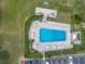 Aerial view of community pool, lounge area, seating, and parking at 220 Belleview Blvd # 108, Belleair, FL 33756