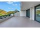 Balcony overlooking lush trees, blending indoor comfort with outdoor serenity at 220 Belleview Blvd # 108, Belleair, FL 33756