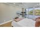 Well-lit bedroom with a large window, wood floors, and a ceiling fan at 220 Belleview Blvd # 108, Belleair, FL 33756