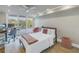 Bright bedroom with floor-to-ceiling windows, desk, and wood-style flooring at 220 Belleview Blvd # 108, Belleair, FL 33756