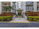 Inviting building entrance featuring well-maintained landscaping and prominent address display at 220 Belleview Blvd # 108, Belleair, FL 33756