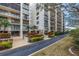 Well-maintained, multi-story condo building with manicured landscaping and entryway at 220 Belleview Blvd # 108, Belleair, FL 33756