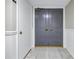 Elegant front door with decorative details and polished hardware, situated in a hallway at 220 Belleview Blvd # 108, Belleair, FL 33756