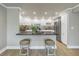 Stylish kitchen featuring white cabinetry, sleek countertops, and barstool seating at 220 Belleview Blvd # 108, Belleair, FL 33756