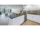 Stylish kitchen island featuring an open concept design with a stainless steel dishwasher and sink at 220 Belleview Blvd # 108, Belleair, FL 33756