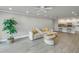 Spacious living room with a neutral palette, modern flooring, and a view to the kitchen at 220 Belleview Blvd # 108, Belleair, FL 33756