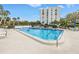 Inviting swimming pool surrounded by lush landscaping, providing a tranquil oasis for residents to enjoy at 220 Belleview Blvd # 108, Belleair, FL 33756