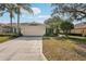 Inviting one-story home with a well-maintained yard, palm trees, and a two-car garage at 2333 Brookfield Greens Cir, Sun City Center, FL 33573