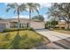 Charming single-story home with lush landscaping, attached garage, and a well-manicured lawn at 2333 Brookfield Greens Cir, Sun City Center, FL 33573