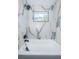 Clean bathroom with a bathtub and marble wall tile at 2835 Freemont S Ter, St Petersburg, FL 33712