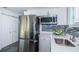 Modern kitchen with stainless steel appliances and white cabinets at 2835 Freemont S Ter, St Petersburg, FL 33712
