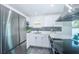 Bright kitchen with stainless steel appliances and white cabinets at 2835 Freemont S Ter, St Petersburg, FL 33712