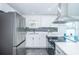 Modern kitchen with stainless steel appliances and gray tile floors at 2835 Freemont S Ter, St Petersburg, FL 33712