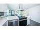 Modern kitchen with island, stainless steel appliances, and white cabinets at 2835 Freemont S Ter, St Petersburg, FL 33712