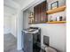 Laundry room with washer, dryer, and built-in shelving at 2835 Freemont S Ter, St Petersburg, FL 33712