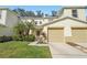 Charming townhome with a well-manicured lawn, lush landscaping, and a two-car garage at 2938 Royal Tuscan Ln, Valrico, FL 33594