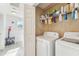 Laundry room with white washer and dryer and shelving at 2938 Royal Tuscan Ln, Valrico, FL 33594