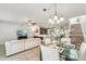 Bright living and dining area with tile floors, modern lighting, and an open layout at 2938 Royal Tuscan Ln, Valrico, FL 33594