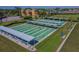 Aerial view of a shuffleboard field surrounded by shady seating with nearby parking at 301 Andover S Pl # 185, Sun City Center, FL 33573
