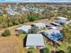 Aerial view of a well maintained property featuring a light grey roof, landscaping, and carports at 301 Andover S Pl # 185, Sun City Center, FL 33573