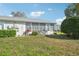 Backyard exterior featuring a parked bicycle and lush landscaping enhancing the home's curb appeal at 301 Andover S Pl # 185, Sun City Center, FL 33573