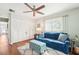 Relaxing bedroom featuring a comfortable blue sofa, patterned ottoman, and ample closet space at 301 Andover S Pl # 185, Sun City Center, FL 33573