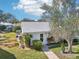 Charming single-story home with a well-manicured lawn and a welcoming front entrance at 301 Andover S Pl # 185, Sun City Center, FL 33573