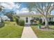Charming single-story home with a well-manicured lawn and landscaped front yard, creating an inviting curb appeal at 301 Andover S Pl # 185, Sun City Center, FL 33573